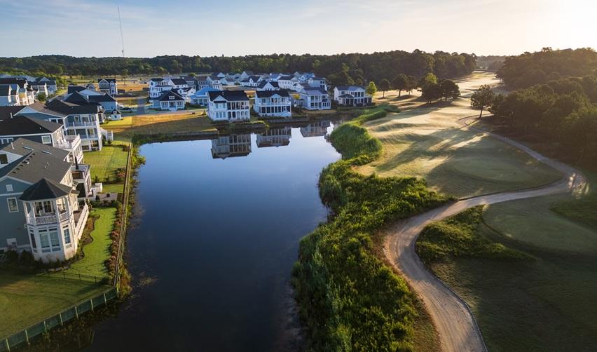 Aerial view of Bay Creek waterfront homes and golf course in Cape Charles, Virginia, showcasing the community appeal behind the EB5 rural investment project.