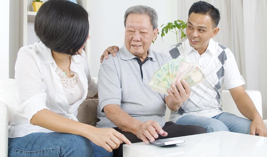 Elderly parent handing money to family members, symbolizing gifted funds for EB5 investment.