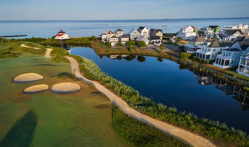 Aerial view of Bay Creek golf course and waterfront homes along the Chesapeake Bay, highlighting the community’s coastal lifestyle and EB5 investment appeal.