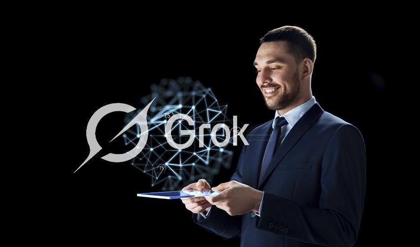 Smiling businessman using a tablet with digital network graphics and the Grok logo, illustrating EB5 investors exploring AI tools for investment decisions.
