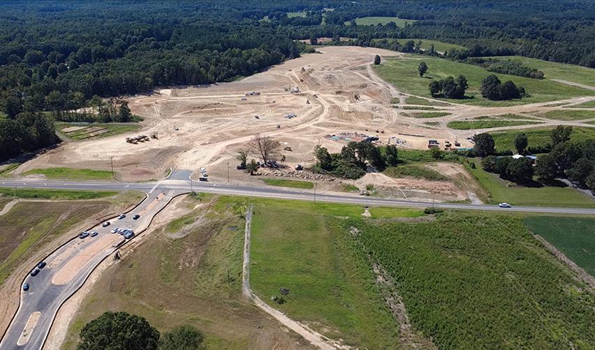 An aerial view of a road and a forest