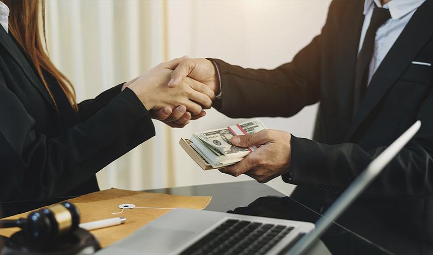 Handshake with money exchange, symbolizing financial support rather than traditional sponsorship in the EB5 process.