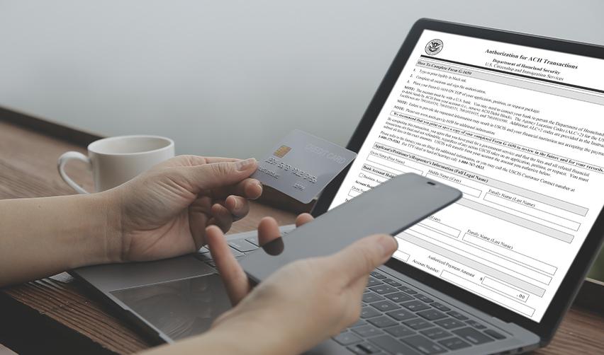 Investor using a laptop with USCIS ACH authorization form displayed while holding a credit card, illustrating the new EB5 electronic payment process.
