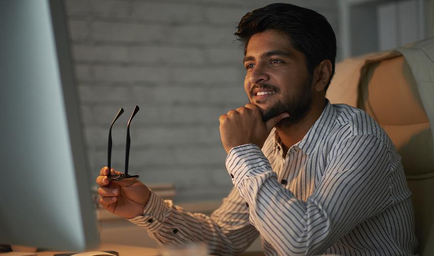 An EB5 investor reviewing visa options late at night, symbolizing thoughtful career planning and analysis of H1B alternatives.