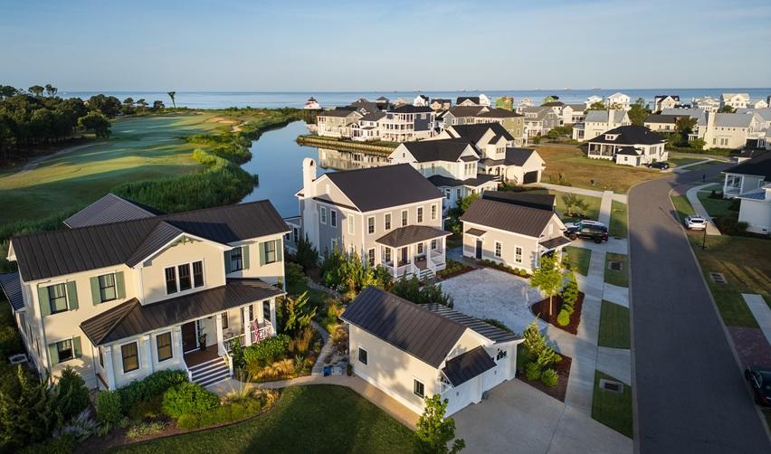 Aerial view of Bay Creek’s coastal neighborhood overlooking the golf course and Chesapeake Bay, highlighting the community’s growing residential development for EB5 investors.