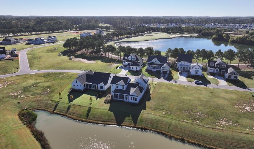 Aerial view of Bay Creek’s completed lakeside homes and golf course in Cape Charles, Virginia, showcasing community growth and natural waterfront surroundings for EB5 investors.