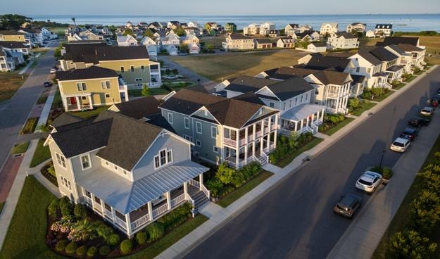 Bay Creek coastal community with rows of modern homes overlooking the Chesapeake Bay, symbolizing a thriving development supported by EB5 investment.