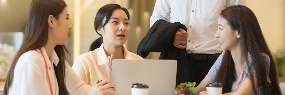 Asian professionals discussing U.S. visa options, including EB5 vs Gold Card.