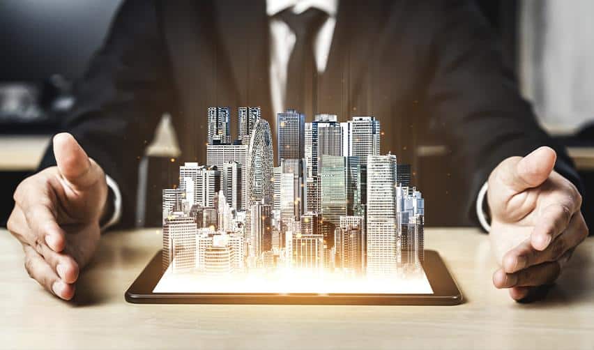 Businessperson holding a digital model of a city emerging from a tablet, illustrating EB5 real estate development and economic expansion through investment.