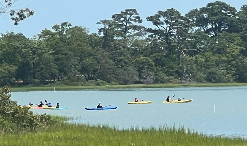 Members kayaking along Bay Creek’s scenic waterways surrounded by lush trees and wetlands, showcasing outdoor recreation that strengthens EB5 project demand.