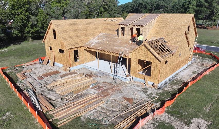 Construction crew framing a new single-family home at Bay Creek in Cape Charles, Virginia, highlighting active residential development progress under the rural EB5 project.