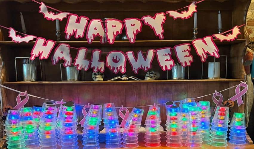 Halloween decorations and glowing cups displayed inside the Coach House for Bay Creek’s late-October celebrations.