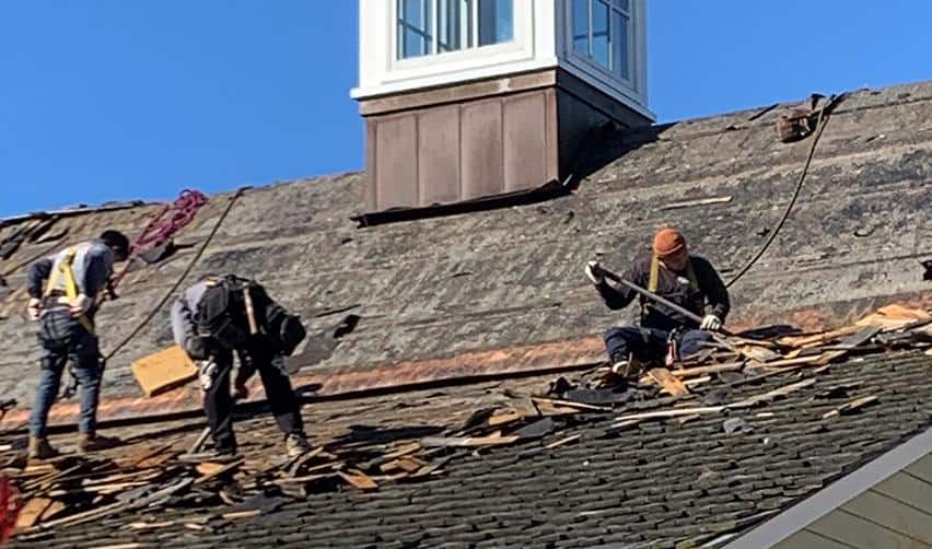Workers working on the roof replacement of Clubhouse, showing steady progress in the renovations being made at Bay Creek rural EB5 project site.