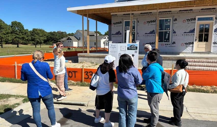 EB5AN site visit participants touring an active home construction site at Bay Creek, observing development progress and learning about future residential phases.