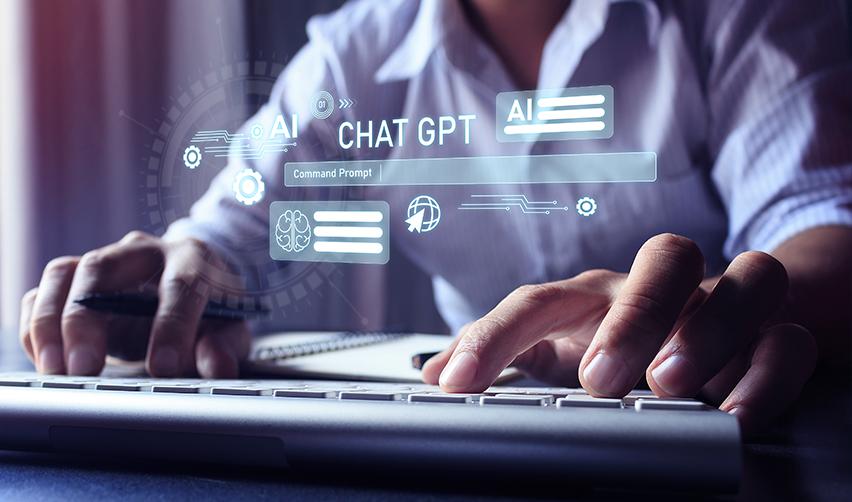 Person typing on a keyboard with digital AI interface and ChatGPT commands projected on screen, symbolizing EB5 investors using AI tools to analyze visa processing times and approval data.