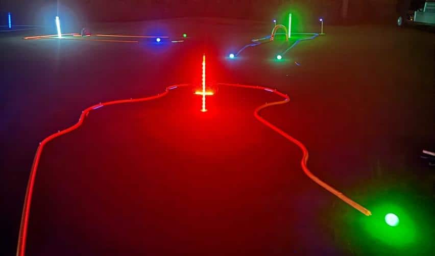 Neon-lit putting course glowing in red, green, and blue during Bay Creek’s Glow Putt: Ghouls Edition event at the Clubhouse.