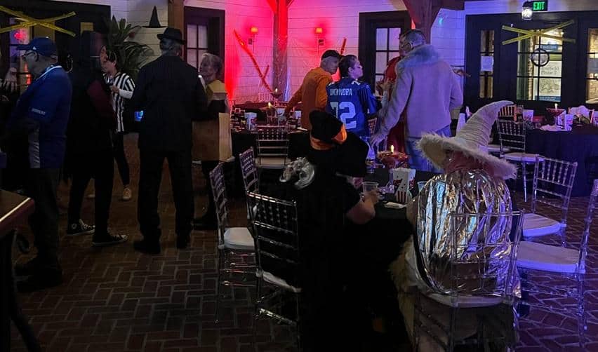 Residents in costumes enjoying the Halloween Costume Cocktail Party inside the Coach House at Bay Creek.
