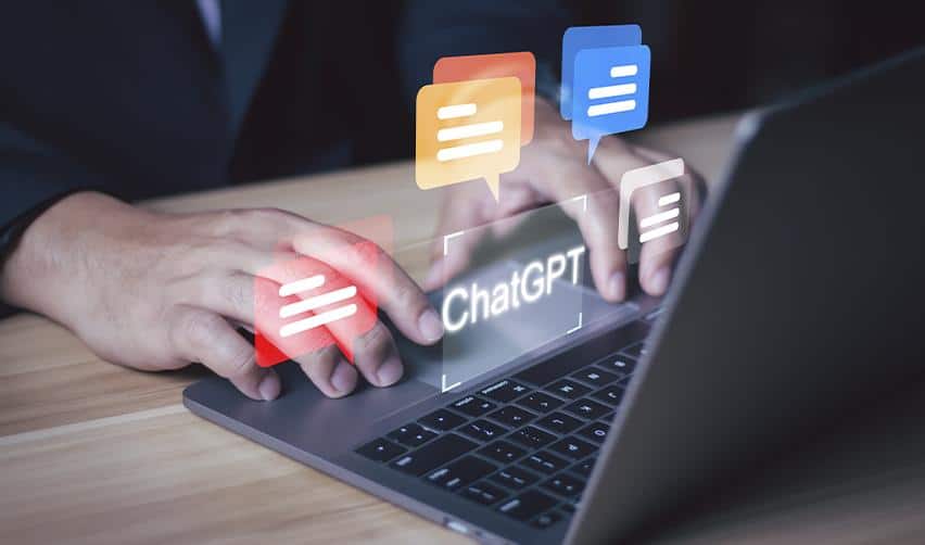Hands typing on a laptop surrounded by colorful chat icons labeled ChatGPT, representing EB5 investors engaging with AI to understand immigration timelines and approval chances.