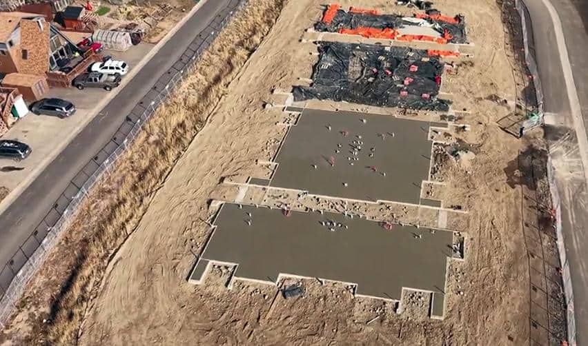 Aerial shot of newly poured concrete foundations at Grand Park, highlighting active site preparation and early vertical construction activity for upcoming residential units.