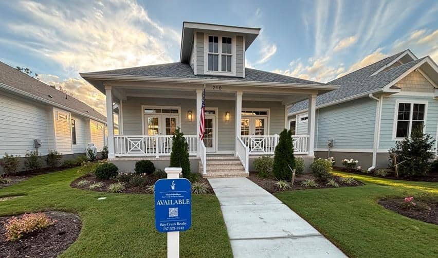 A newly completed home at Bay Creek with a manicured lawn and sunset sky, representing ongoing residential growth within the EB5 rural community project.