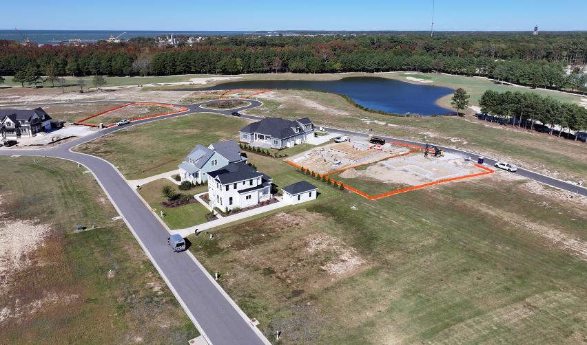Ongoing home construction and cleared lots near the golf course and lake at Bay Creek, highlighting active residential development supported by EB5 investment.