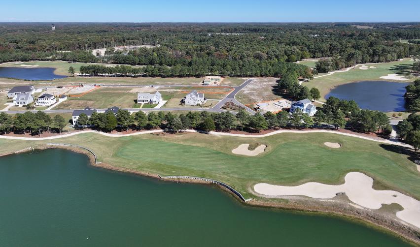 Panoramic aerial of Bay Creek’s golf course and lakeside neighborhoods, illustrating steady EB5-funded infrastructure and housing growth.