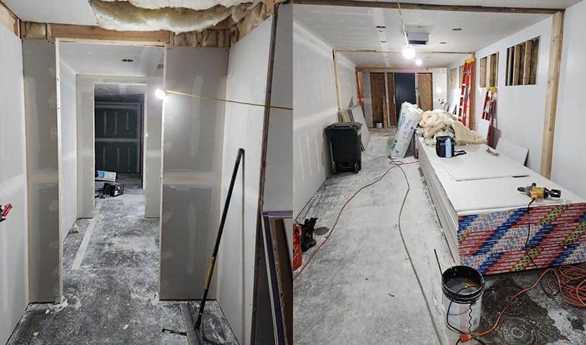 Interior construction image showing drywall installation, framing adjustments, and ongoing renovation work inside the Bay Creek locker rooms.
