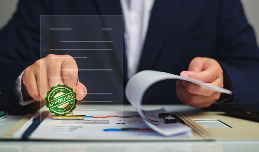 An investor reviewing paperwork with an approved stamp, representing EB5 project due diligence, documentation review, and clear investment structures.