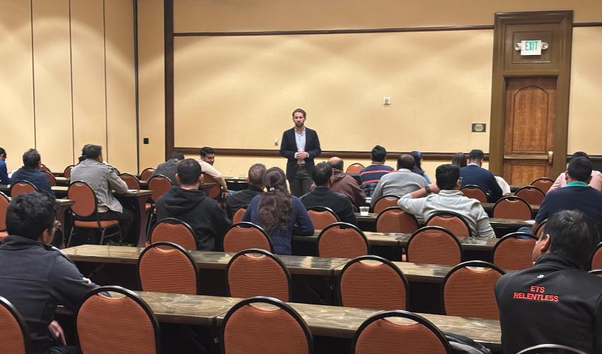 A room of EB5 investors seated in rows listening to Jordan Lawrence speak during the recent EB5AN event, highlighting strong turnout and engagement at the EB5AN meetup.