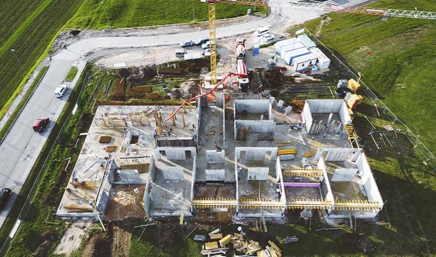 Aerial view of residential construction in progress, showing straightforward EB5 job creation through visible building activity and phased real estate development.