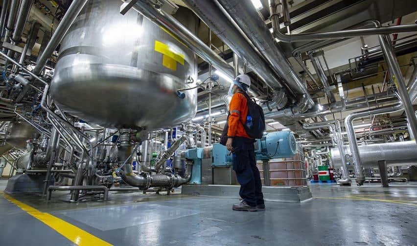 An industrial facility with complex machinery and pipelines, illustrating highly technical EB5 projects that are difficult for investors to evaluate and model.
