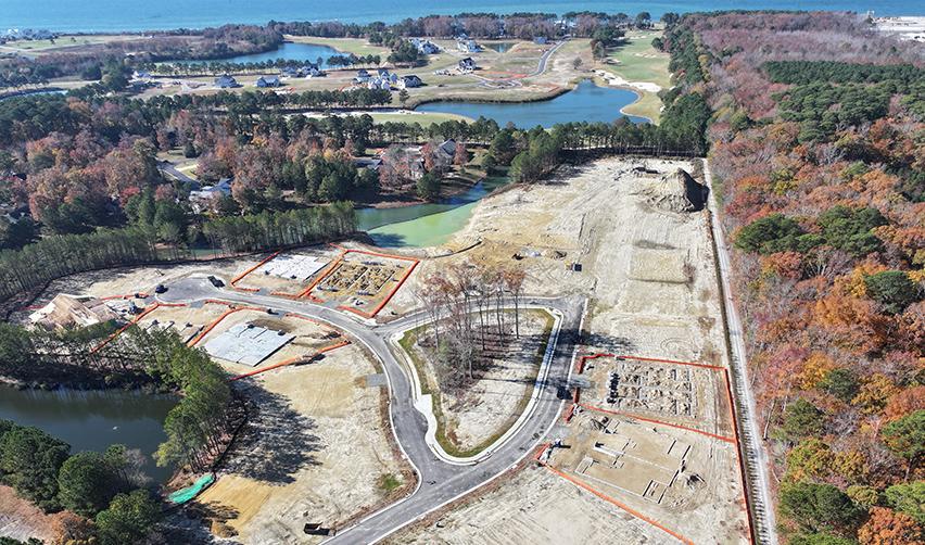Aerial image of Bay Creek capturing cleared land, active foundation work, and construction zones outlined as new homesites take shape.