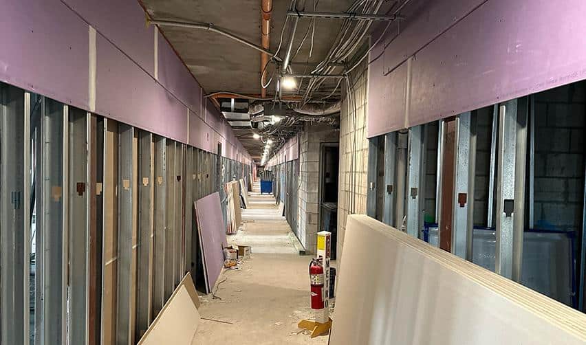Interior corridor at Boynton Beach Multifamily with framing, insulation, and drywall installation underway, marking the transition to interior finishing on this urban EB5 project.