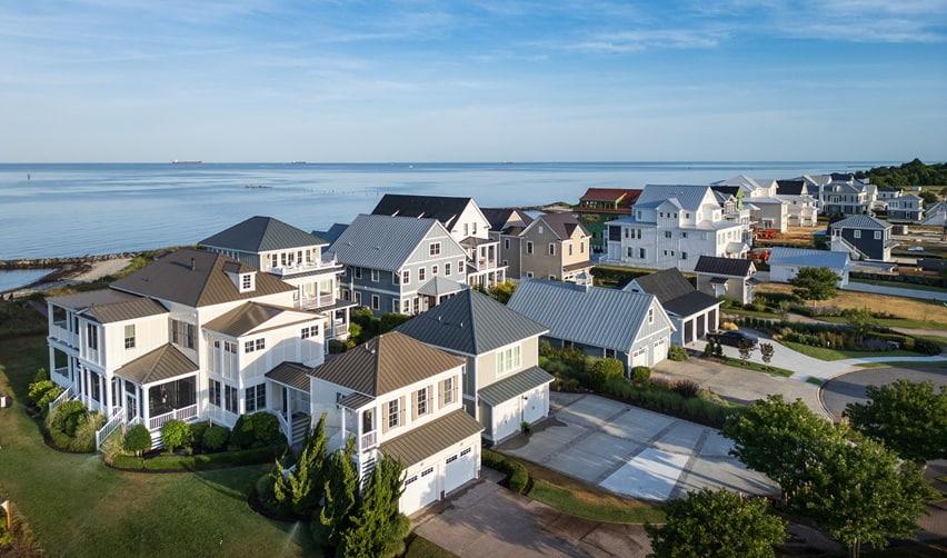 An aerial view of Bay Creek’s coastal homes overlooking the Chesapeake Bay, highlighting the community’s residential appeal and strong year-round activity.