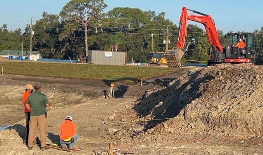 Excavators and onsite supervisors working at the Terra Ceia Multifamily EB5 development, shaping the land and overseeing grading activity during construction.