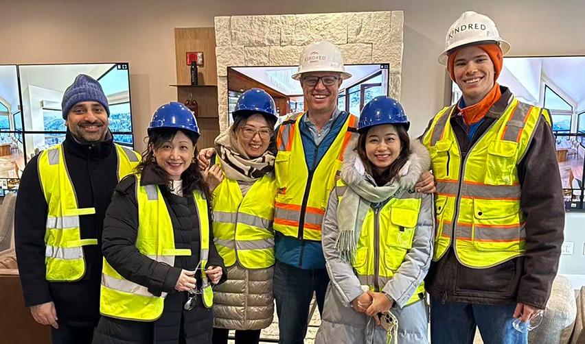 A group of EB5AN team members wearing safety vests and hard hats during a guided site tour, highlighting firsthand engagement at rural EB5 projects Bay Creek and Grand Park.