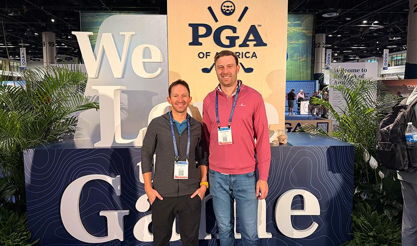 Sam Silverman and Mike Schoenfeld standing at the PGA of America booth during the PGA Show, representing Bay Creek and EB5AN while attending meetings with golf industry leaders.