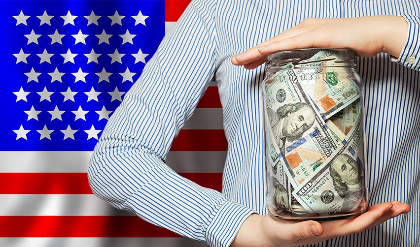 A person holding a glass jar filled with US dollar bills in front of an American flag, symbolizing EB5 investment capital and the protection of investor funds in senior EB5 loan projects.