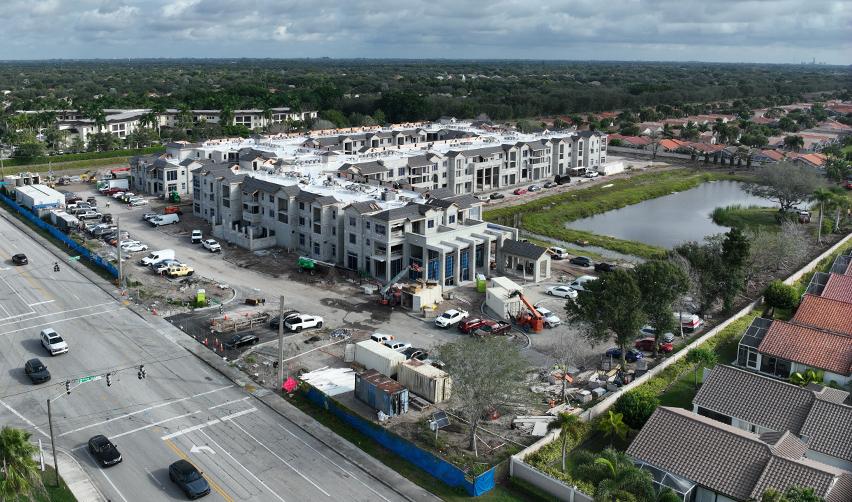 Wide aerial view of the Boynton Beach Multifamily construction site, highlighting multiple residential buildings nearing enclosure within a strong urban Florida market for EB5 investment.