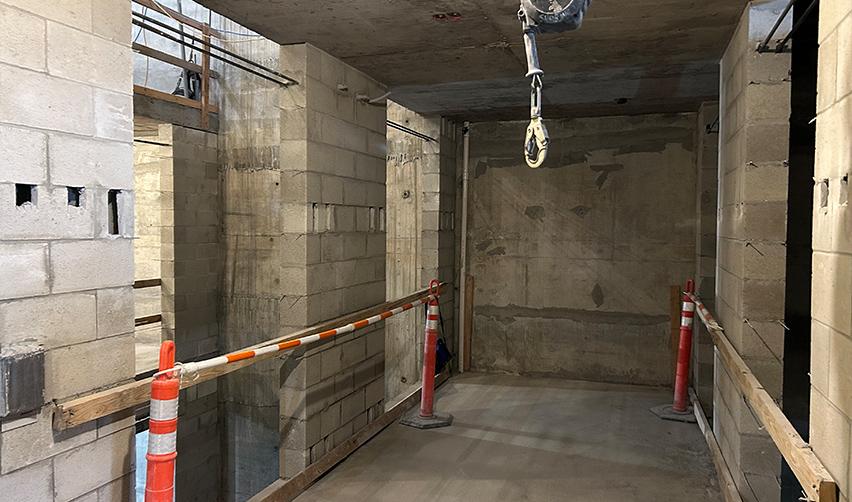 Concrete block interior walls and structural framing inside ONE Tampa, illustrating progress on core building components for the EB5 condominium project.