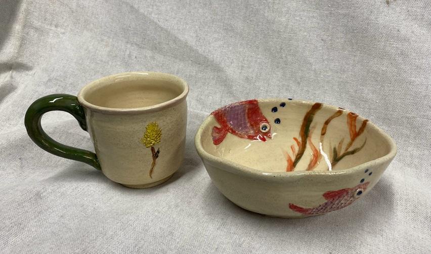 Handcrafted ceramic mug and bowl created during a Bay Creek pottery workshop, featuring nature-inspired designs.