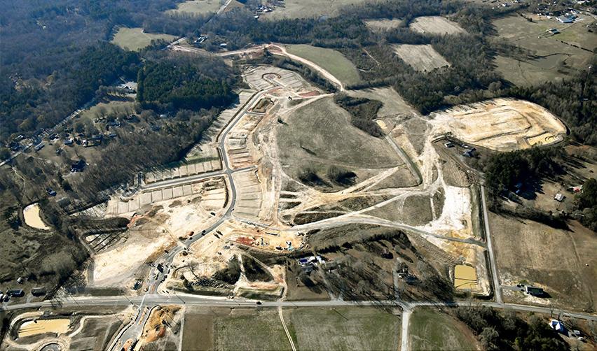Aerial view of site grading and road layout at the Rocky River EB5 rural community in North Carolina, showing initial infrastructure development and cleared residential parcels