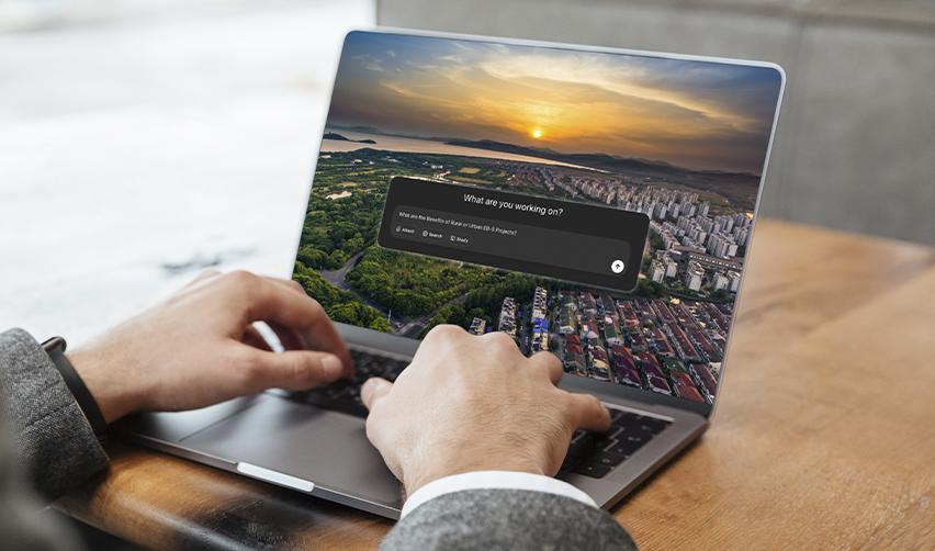 A laptop displaying the ChatGPT interface over a city skyline at sunset, representing EB5 investors using AI tools to analyze rural and urban project options and immigration timelines.