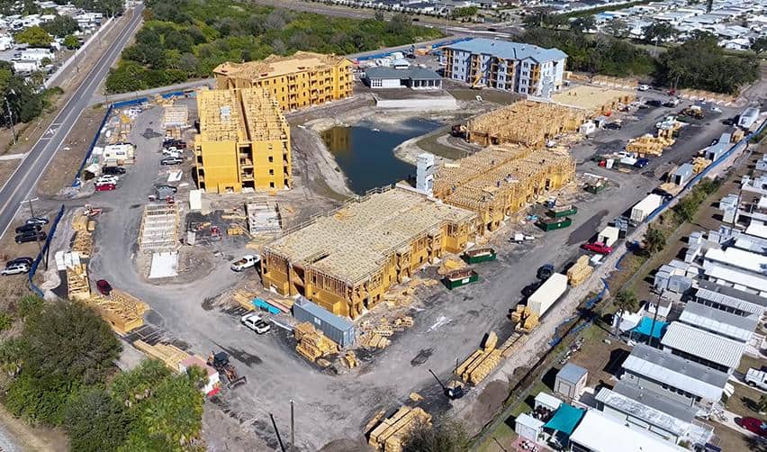 Overhead drone shot of Terra Ceia Multifamily framing progress and roofing installation across several EB5-funded residential buildings.