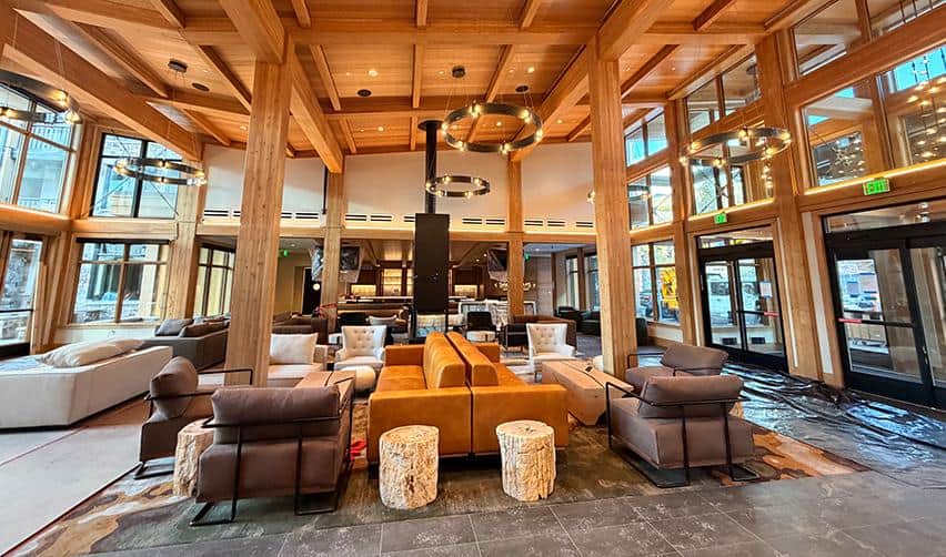 Interior lobby and lounge space at Kindred Resort at Keystone featuring exposed wood beams and seating areas, reflecting luxury finishes prepared for opening under a rural EB5 development.