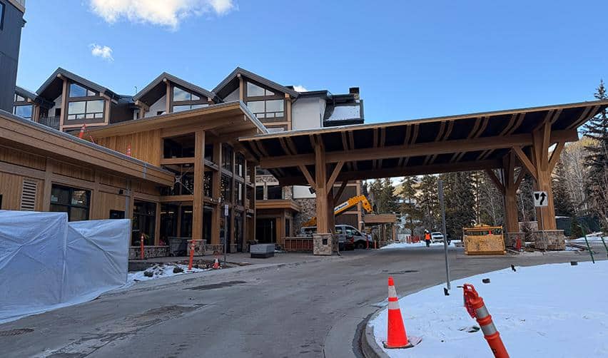 Main arrival and drop-off area at Kindred Resort at Keystone under construction, featuring timber canopy design and completed exterior elements ahead of the EB5 project’s grand opening.