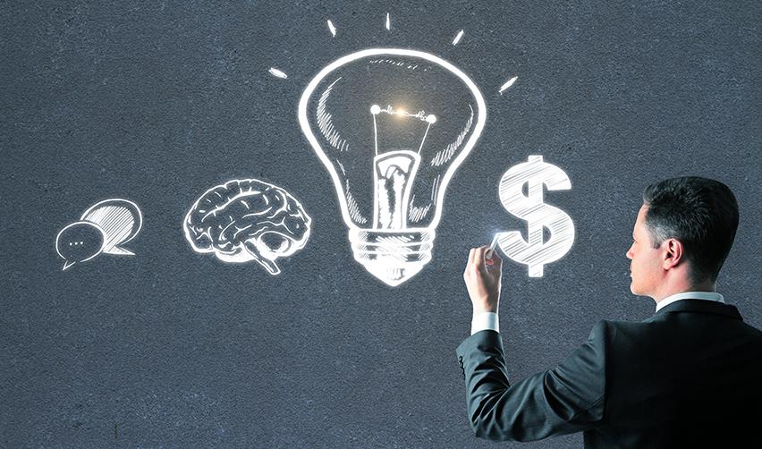 A businessman drawing a lightbulb, brain, and dollar symbol on a chalkboard, representing knowledge, strategy, and financial decision-making in the EB5 investment process.