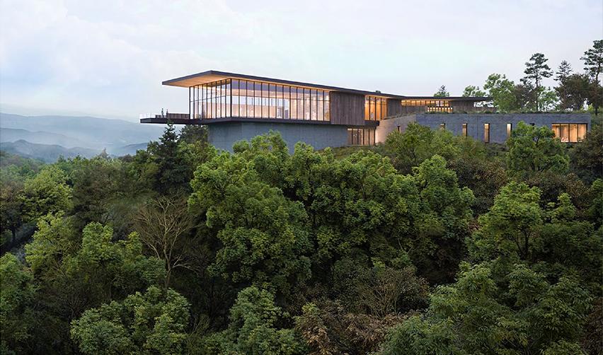 A house on a hill surrounded by trees
