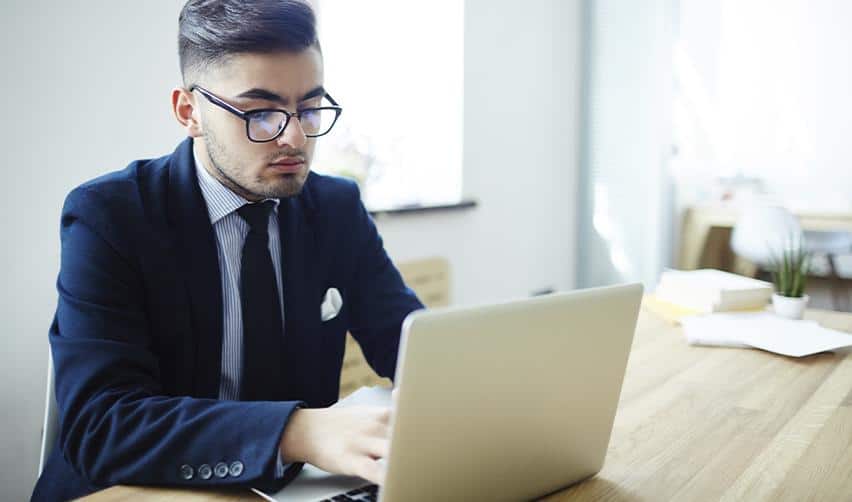 A business professional reviewing information on a laptop, representing an EB5 investor using ChatGPT to research and evaluate regional centers for financial and immigration security.