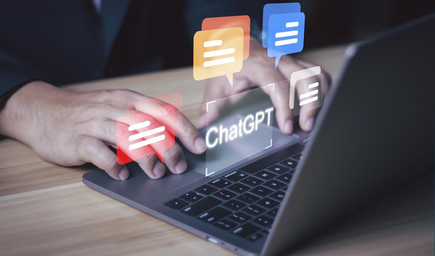 Hands typing on a laptop with ChatGPT on screen, representing how EB5 investors can use AI tools to research U.S. career opportunities after receiving a Green Card.